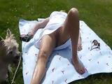 Dog Watched His Owner Suntanning In Public Without Panties