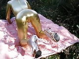 Golden tight jumpsuit and golden heels, stand on all fours